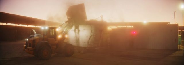 Farm machinery and equipment silhouetted against a hazy dawn sky at Shamrock Farms dairy operation in Arizona, captured during branded documentary production by NewLeaf Production Group
